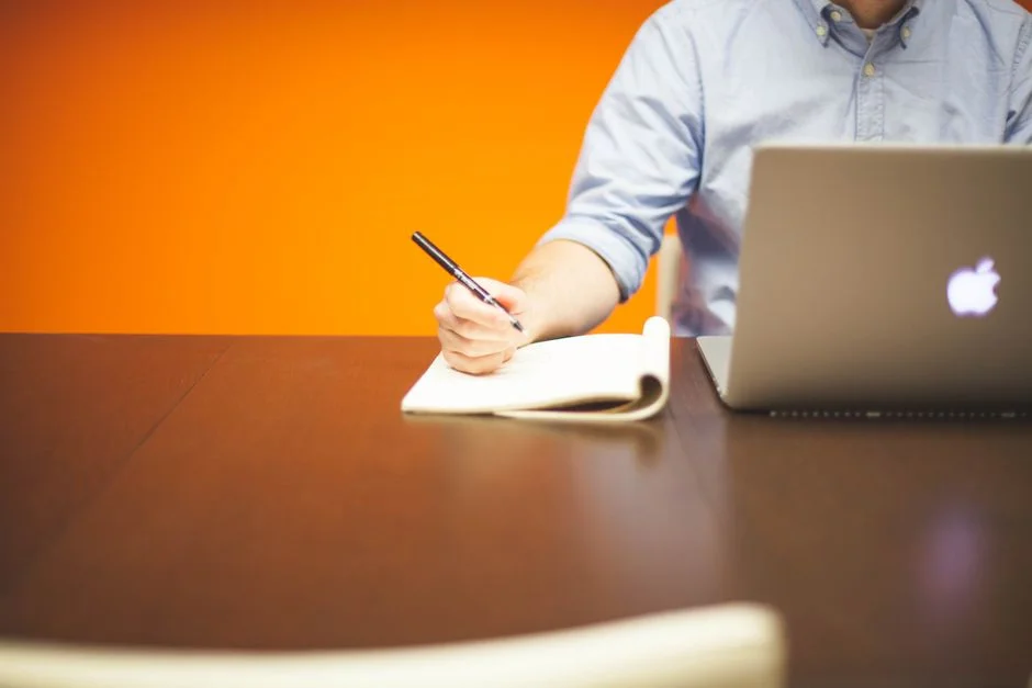 Schreibtischarbeit mit Laptop in einem hellen Büro als Sinnbild für die Profilpflege